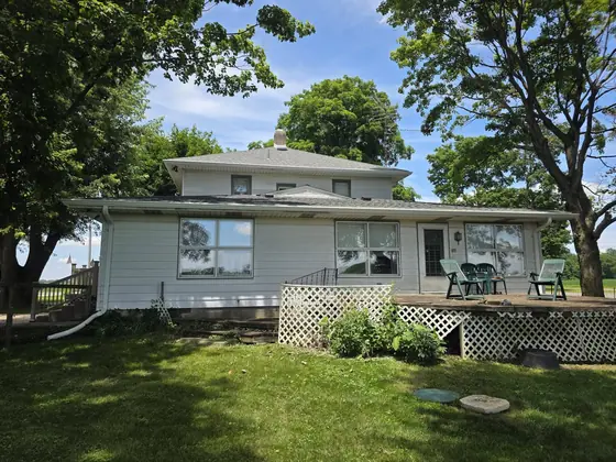 Ranch home with new seamless gutters beside a raised deck